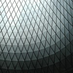 Abstract view of a geometric dome ceiling with a diamond pattern in black and white tones.